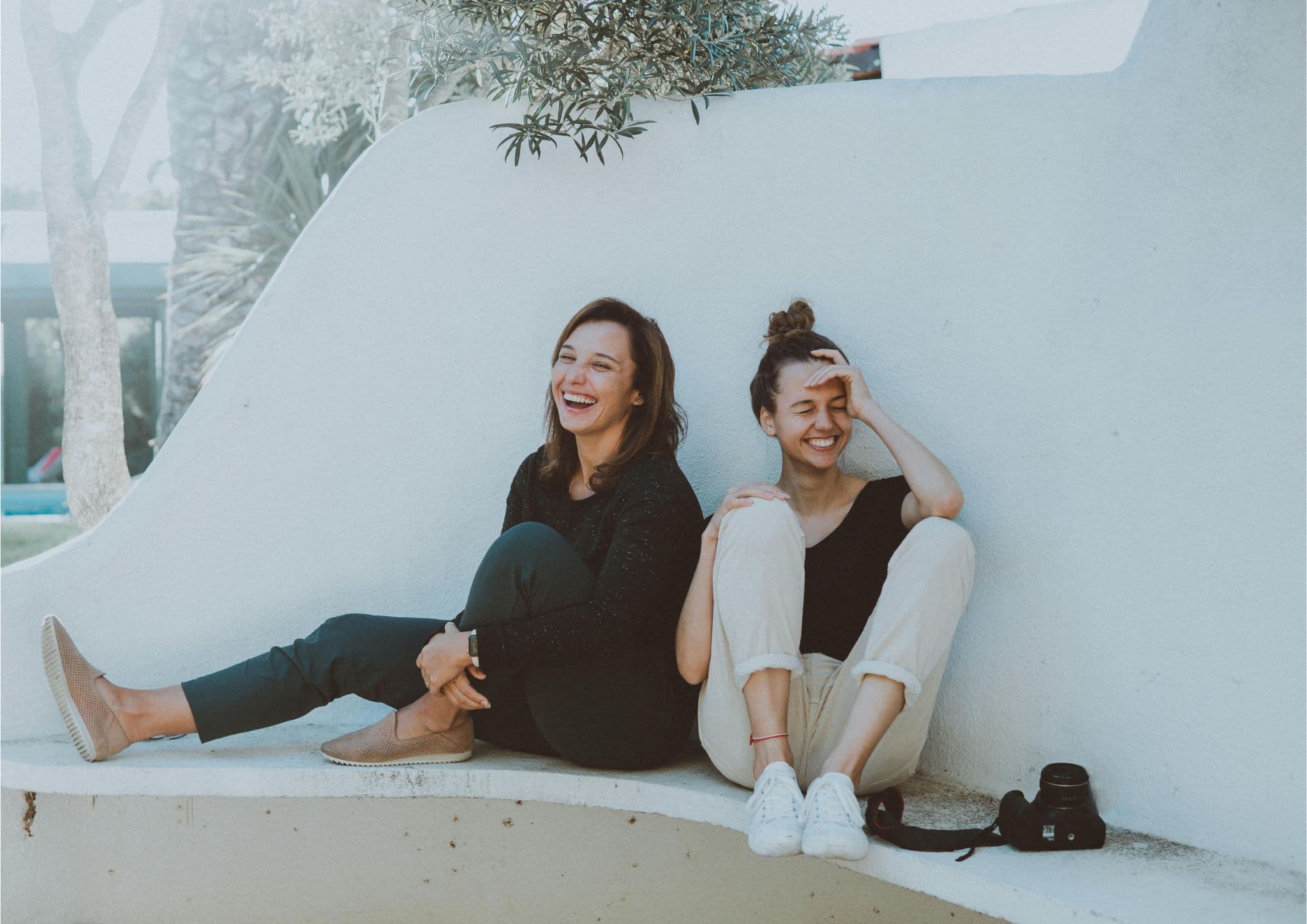 Two women sitting and laughing